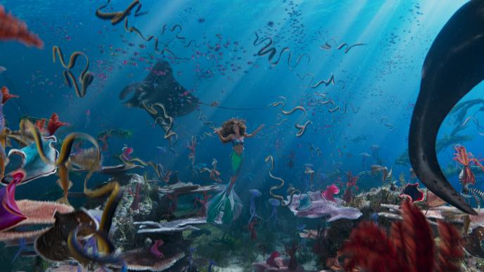 Ariel (Halle Bailey) dances amongst an ensemble of sea creatures