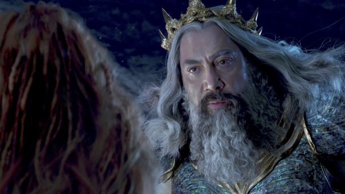 King Triton (Javier Bardem) looks down at Ariel (Halle Bailey) disapprovingly