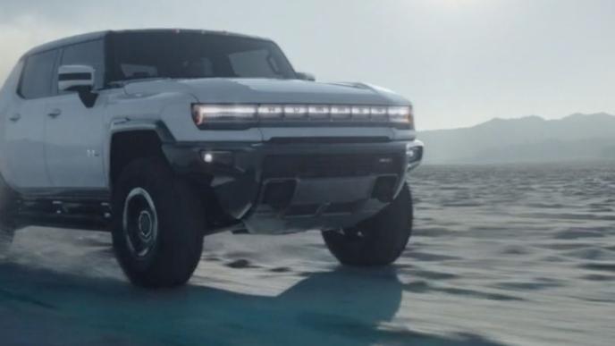 A white Hummer vehicle drives over an icy landscape.