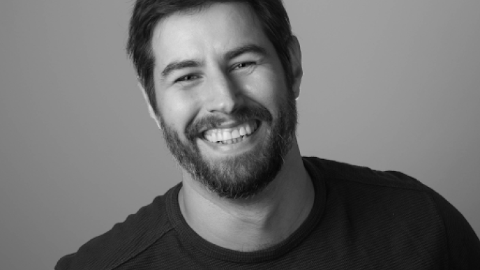 A black and white photo of Jake Cuddihy
