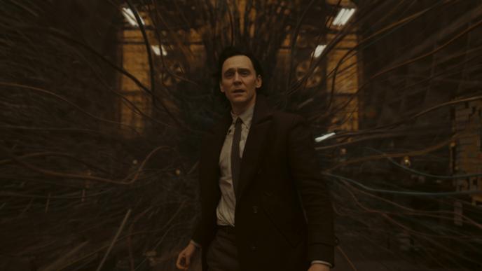 Loki stood in a room as is spaghettifies around him