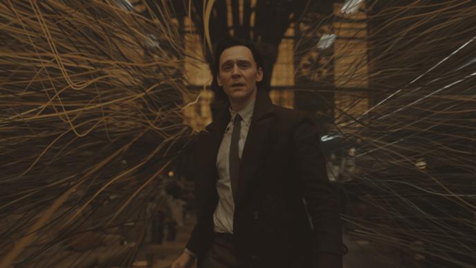 Post vis of Loki stood in a room as is spaghettifies around him