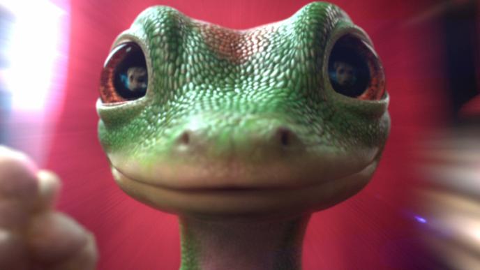 The GEICO gecko stood facing us with a motion blurred red background.
