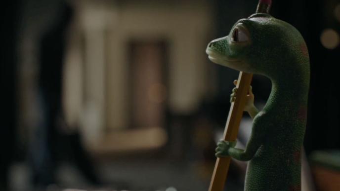 The GEICO Gecko holds a pencil