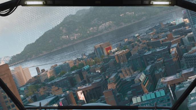 The view of a city block through a heads up display in a aircraft, there is a hill and a body of water in background.