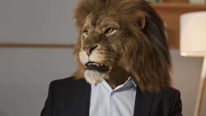 A lion head on a man's body wearing a suit