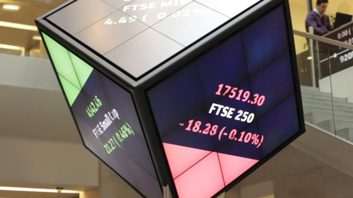 A large cube shaped screen showing different stocks and their positions in the market.
