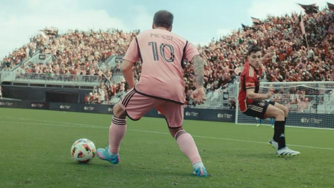 Messi kicking a soccer ball