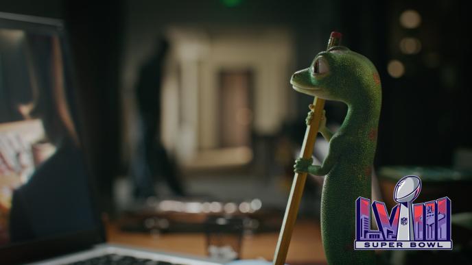 A lizard holding a pencil looking into the distance, there is the Super Bowl LVIII logo in the bottom left corner.