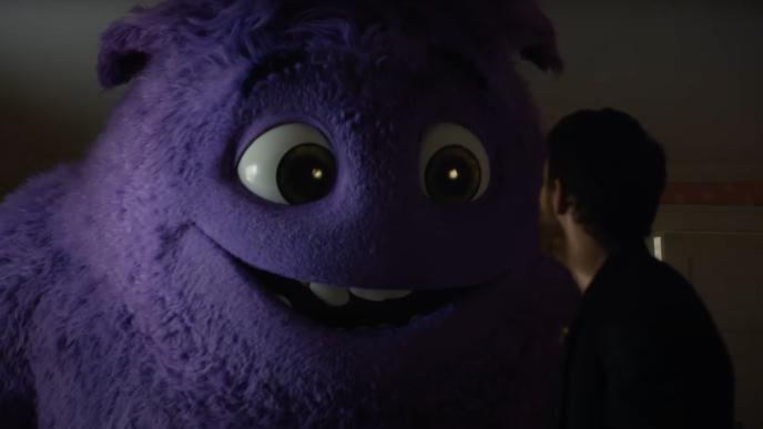 Ryan Reynolds talks to a large purple animated monster