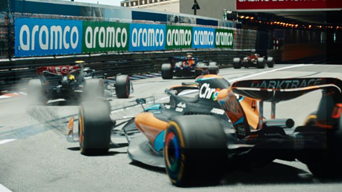 A group of Formula 1 cars are driving through a tunnel. 