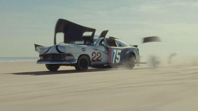 An old car sheds its exterior to reveal a newer racecar underneath 