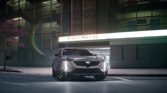 A Cadillac car outside a modern house