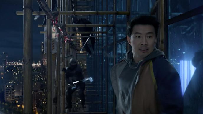 Shang Chi on the side of a skyscraper