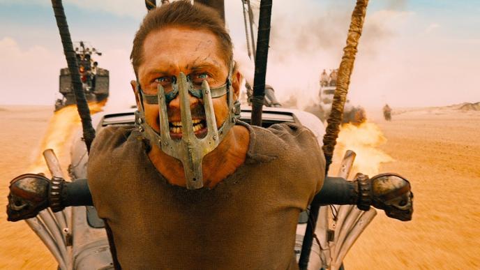 Tom Hardy as Mad Max with a metal mouth restraint on