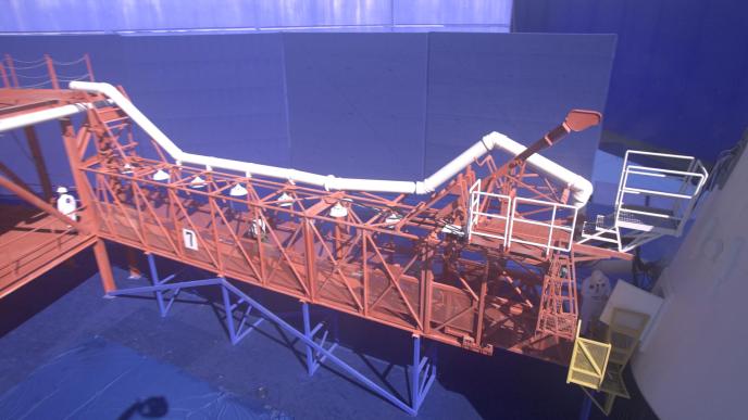 A plate shot from Fly Me to the Moon showing the blue screen around the tunnel to the Saturn V rocket