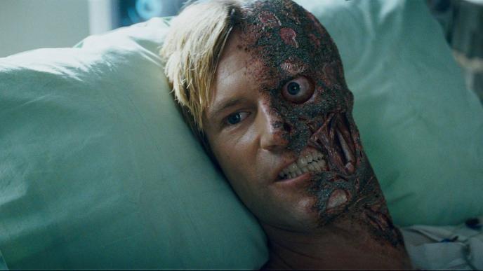 A shot of Harvey Dent in the Dark Knight, half of his face is burnt off, and effect achieved using CGI