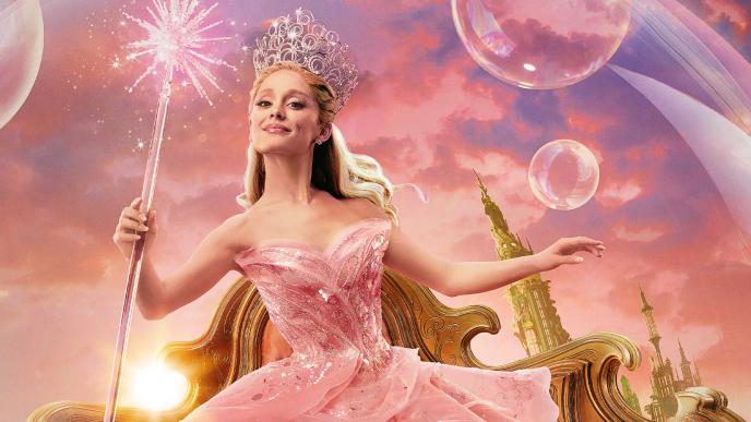 Ariana Grande as Glinda, in a large pink dress, inside a bubble