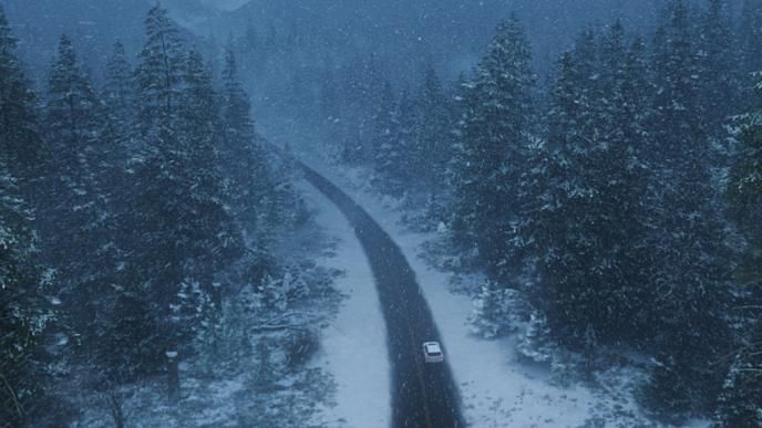 A Lexus SUV drives through a snowy winter environment which was brought to life by Unreal Engine