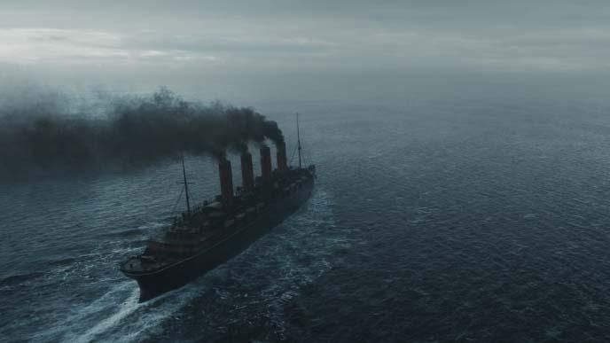 A large boat on an ocean, with four smoking funnels