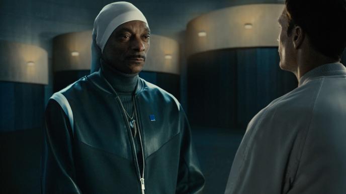 Snoop Dogg and Tom Brady stand facing each other