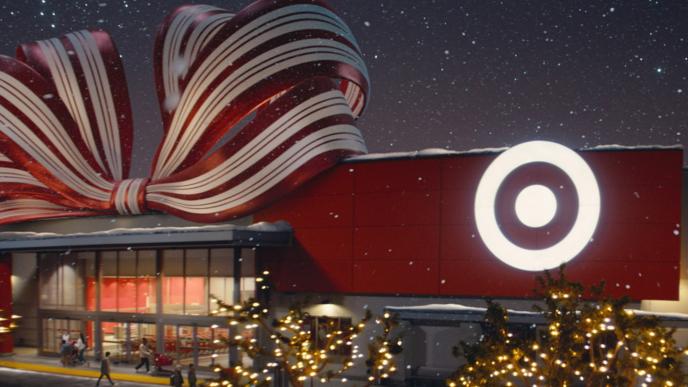 A Target store wrapped in a big bow and its trees covered in Christmas lights