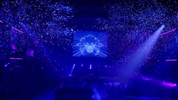 Blue and purple night club with confetti falling from the ceiling