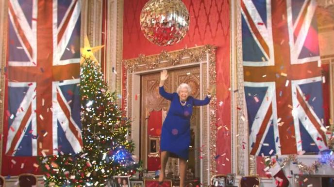 deep fake of the queen under a giant disco ball jumping mid air as confetti surrounds her