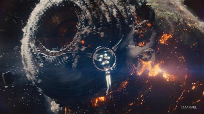 a CGI spaceship bursts through the centre of a planet, causing devastation