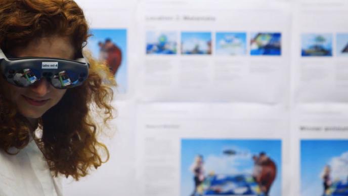 A woman wearing an VR headset in a lab setting.