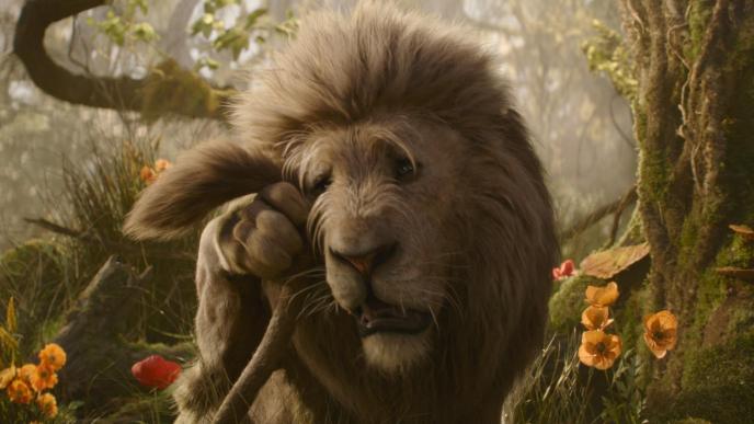 The Cowardly Lion from Wicked: For Good dries tears with his tail. The Lion is CGI Animation, voiced by Colman Domingo.