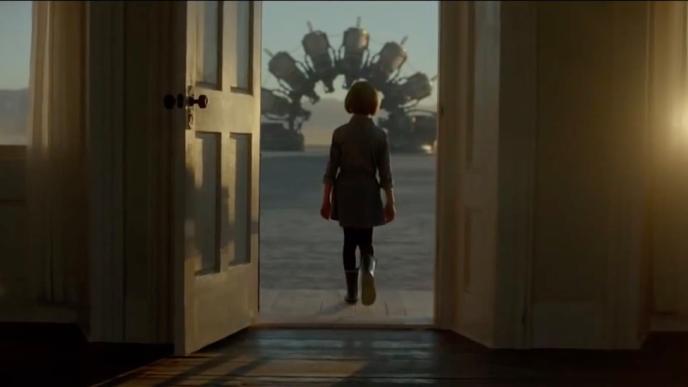 A child walks through an open doorway toward a surreal, circular machine structure outside in warm, golden light.