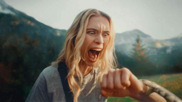 Columbia Sportswear advertisement still of snake biting screaming woman