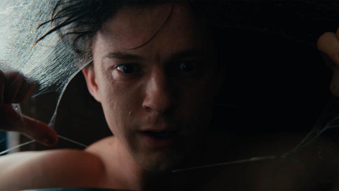 Plate footage of Tom Holland as Spider-Man, looking into camera through prop webs