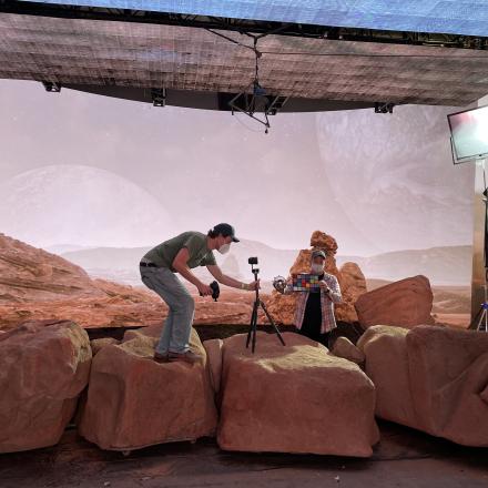 a director checking a camera on a film set
