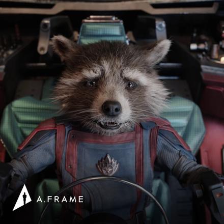 A bipedal raccoon sat in the cockpit of a spaceship in a space suit looking worried, there is the A.Frame logo in the bottom left corner.