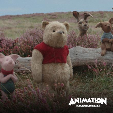 A selection of stuffed toy animals are stood in next to a fallen tree in a field, there is the Animation Magazine logo in the bottom right.