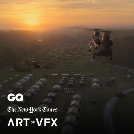 A helicopter flying over a military encampment of tents towards a sunset, there are three press logos in the bottom right corner.