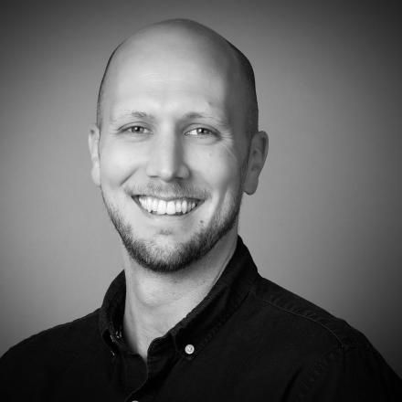A black and white headshot of Gareth Smy