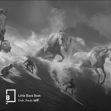 A black and white image showing CG horses coming out a wave among a group of surfers.