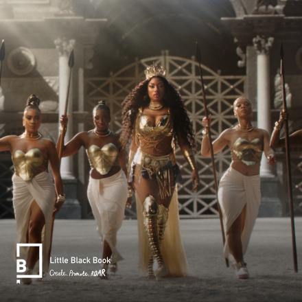 A group of women wearing white flowing dresses and bronze armor are walking into a CG colosseum. 