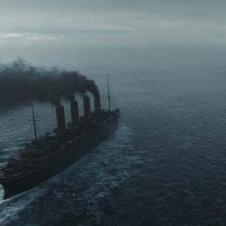 A large boat on an ocean, with four smoking funnels
