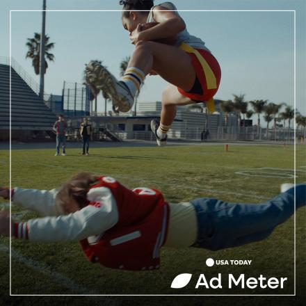 A female flag football player jumps over a male competitor