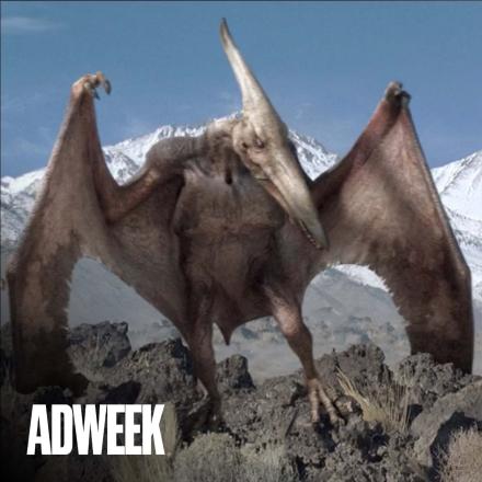 A 3D animated pterodactyl perches itself on a rock
