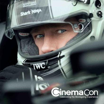 Still of Brad Pitt's character in F1 film with CinemaCon logo