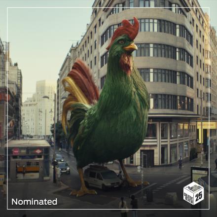 A still image showing a CGI photo-realistic Kellogg's cockerel with green body feathers and red and yellow tail feathers. The Cockerel is almost the size of a building and is walking down the street. 