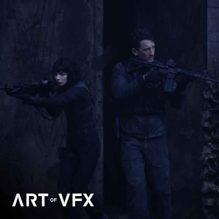 Still of main characters Levi and Drasa in The Gorge film pointing guns outward. Art of VFX logo bottom left