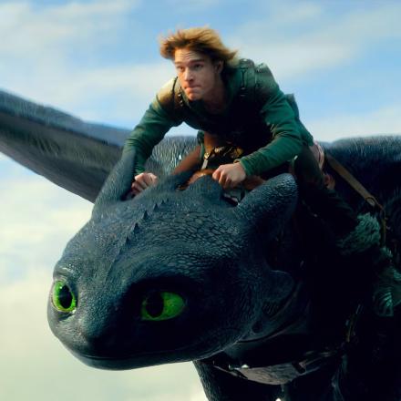 Hiccup from How to Train Your Dragon riding a photoreal animated dragon through the sky.