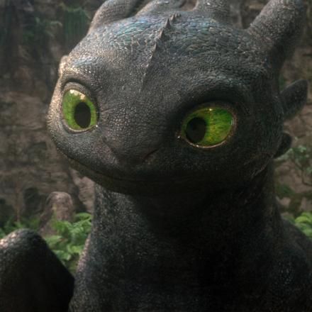 Photo-real CGI Toothless from How To Train Your Dragon cocking his head with curiosity.