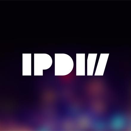 A multicoloured soft background with a white International Production Design Week logo.